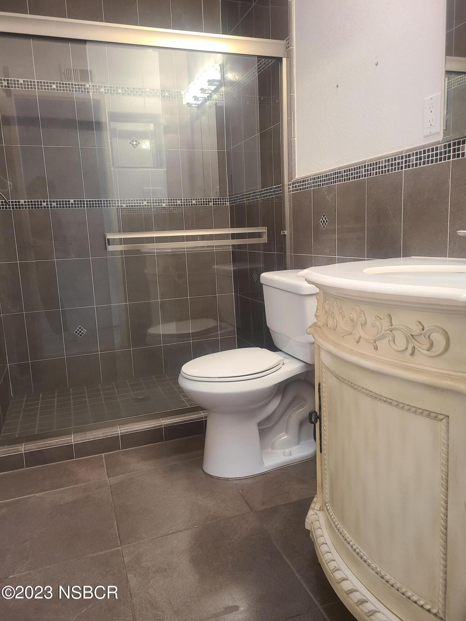 1205 North B Street Lompoc, CA 93436 - Photo 25 of 39 a bathroom with a toilet and a shower