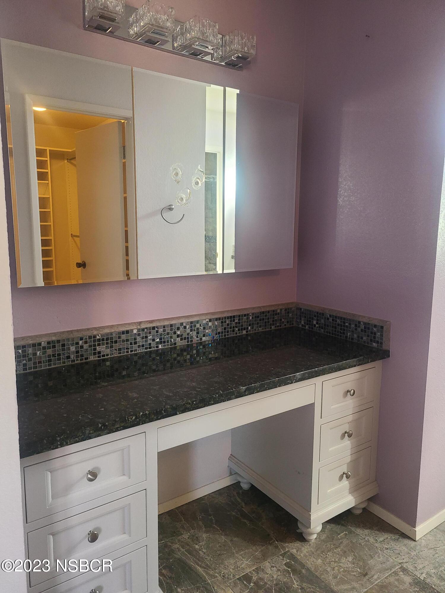 1205 North B Street Lompoc, CA 93436 - Photo 29 of 39 a bathroom with a sink and a mirror