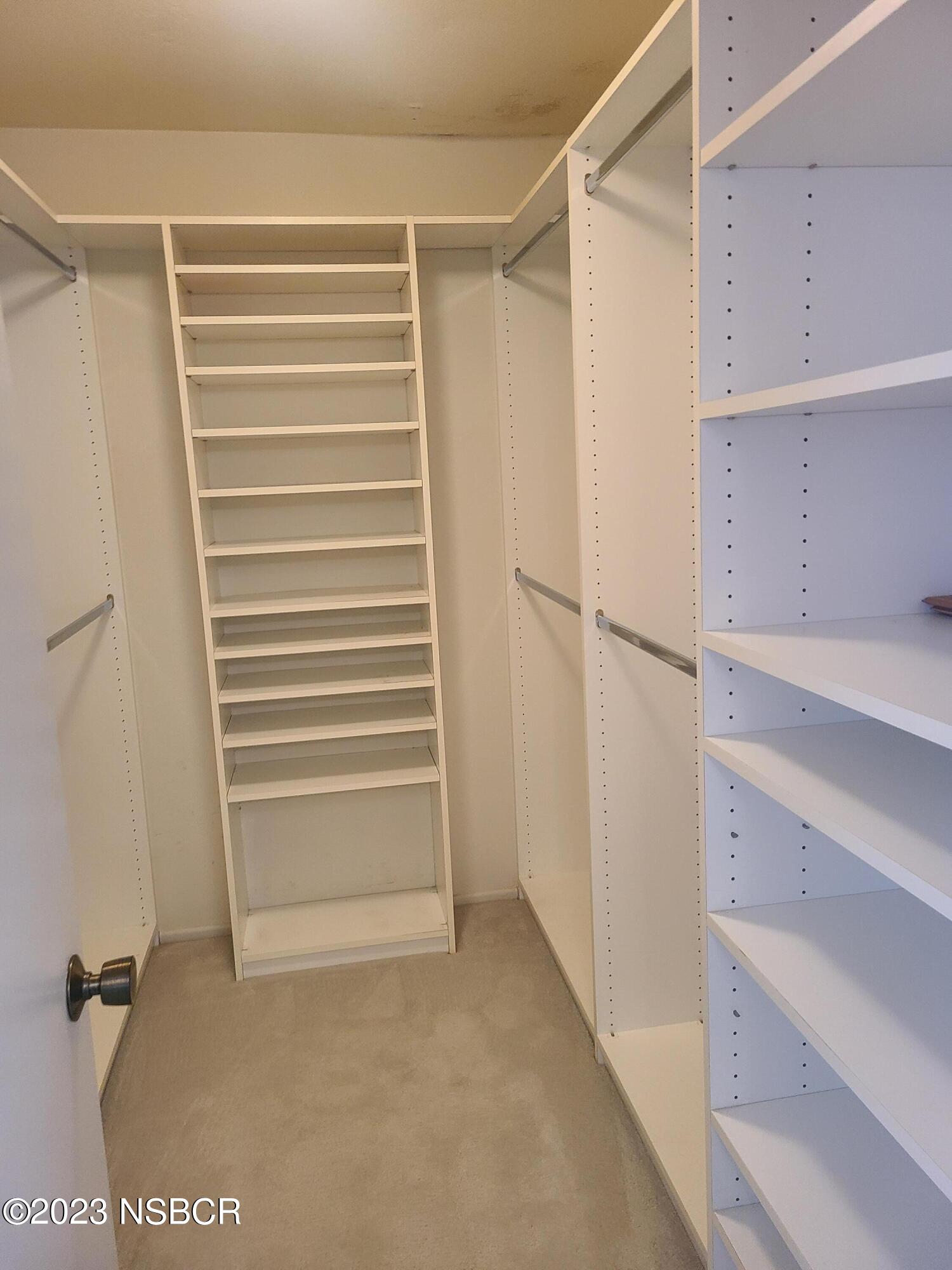 1205 North B Street Lompoc, CA 93436 - Photo 31 of 39 a view of walk in closet with empty racks