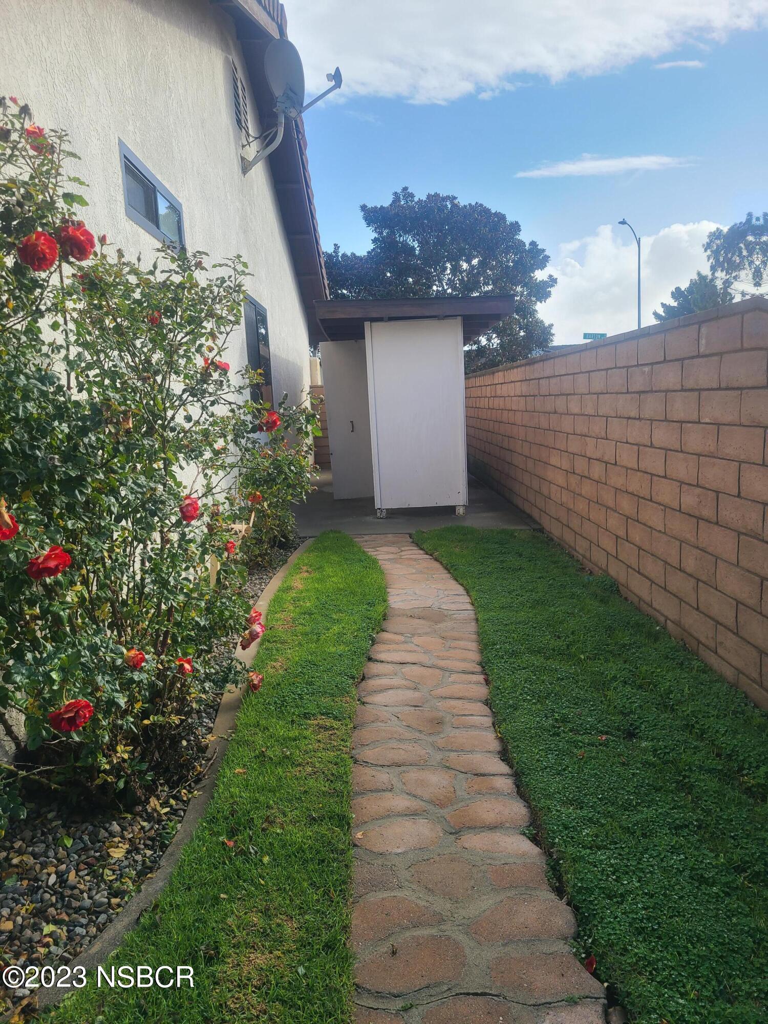 1205 North B Street Lompoc, CA 93436 - Photo 36 of 39 a backyard of a house with lots of green space