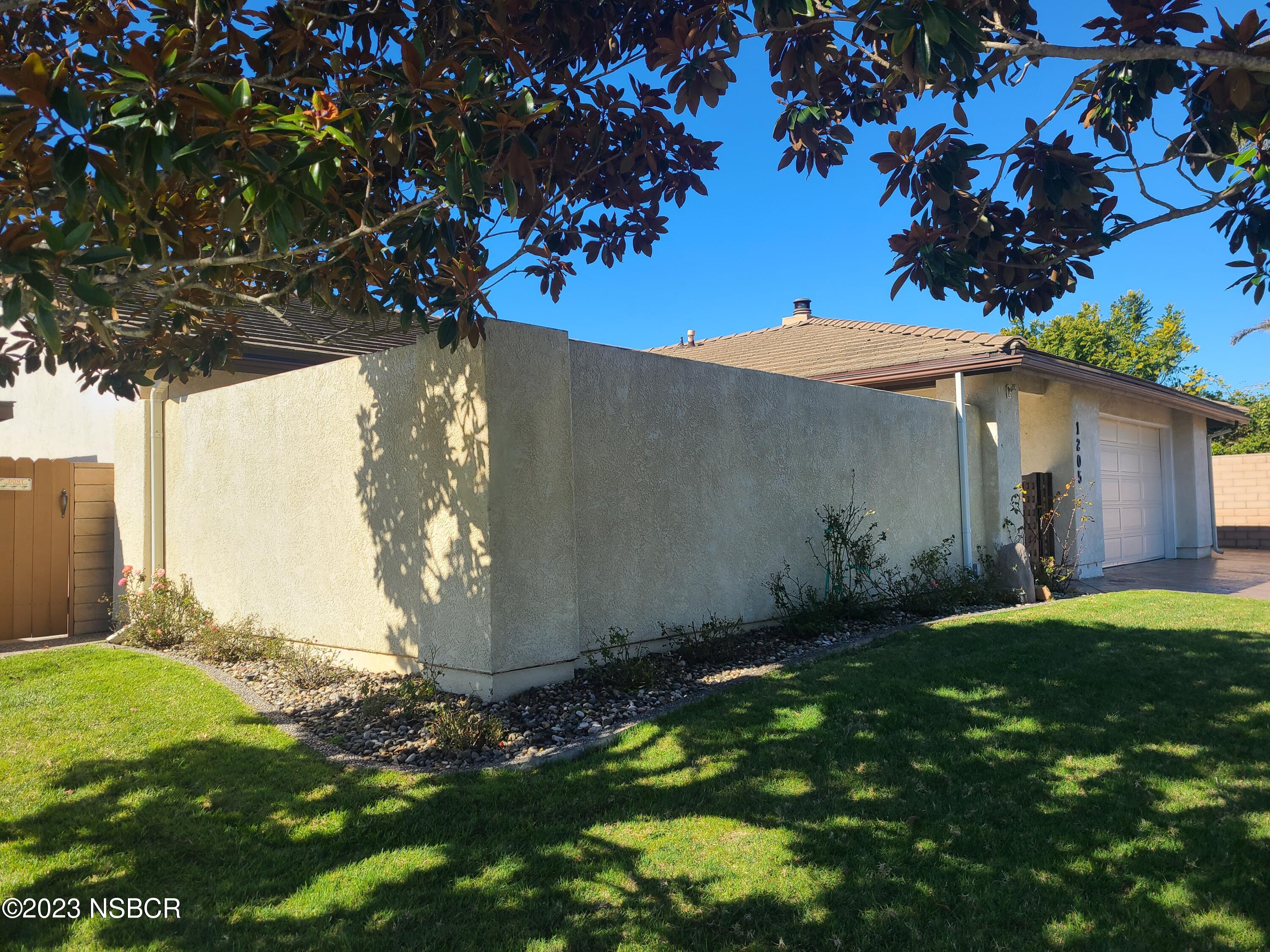 1205 North B Street Lompoc, CA 93436 - Photo 6 of 39 a backyard of a house with lots of green space