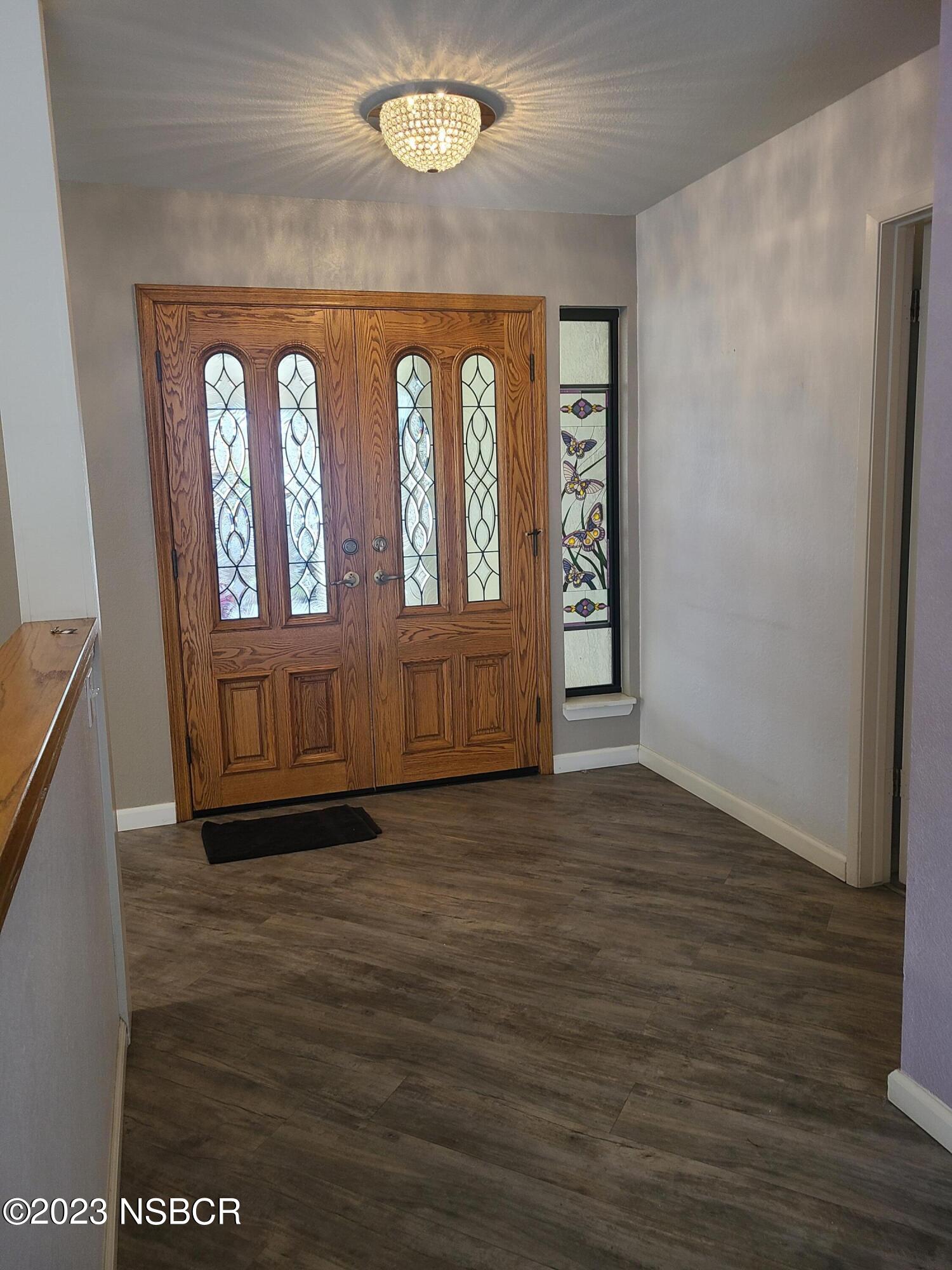 1205 North B Street Lompoc, CA 93436 - Photo 8 of 39 an empty room with wooden floor and windows