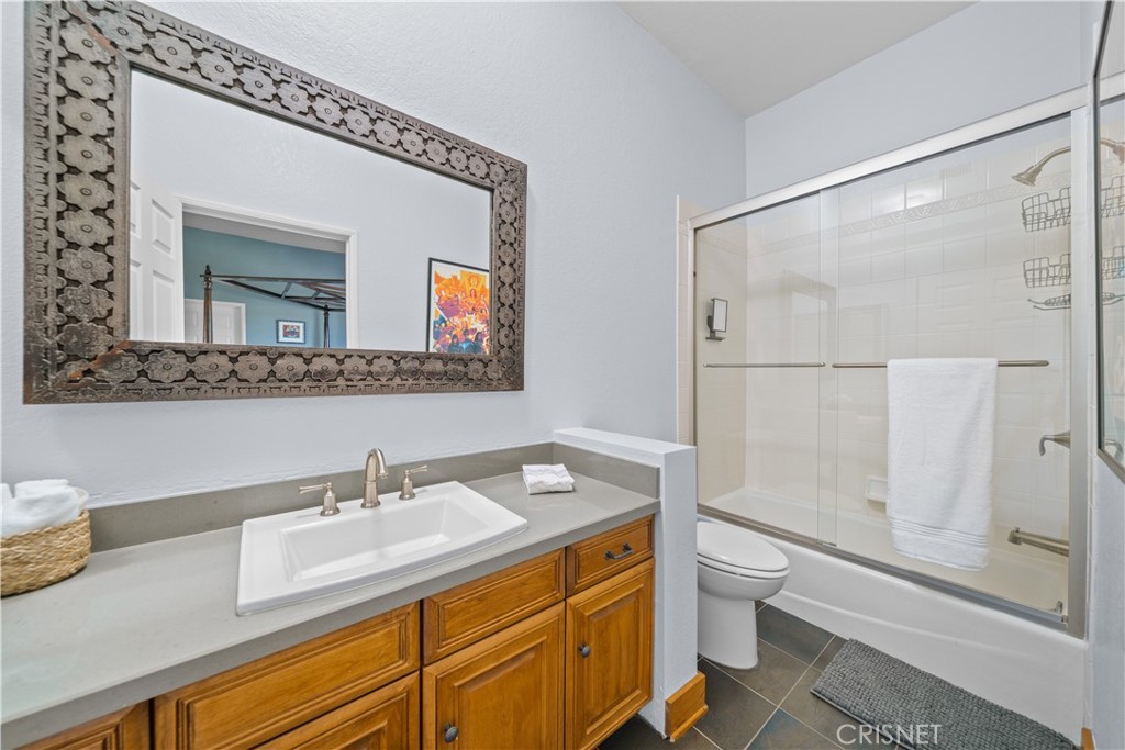 121 Saddlebow Road Bell Canyon, CA 91307 - Photo 25 of 62 a bathroom with a granite countertop sink mirror vanity and toilet