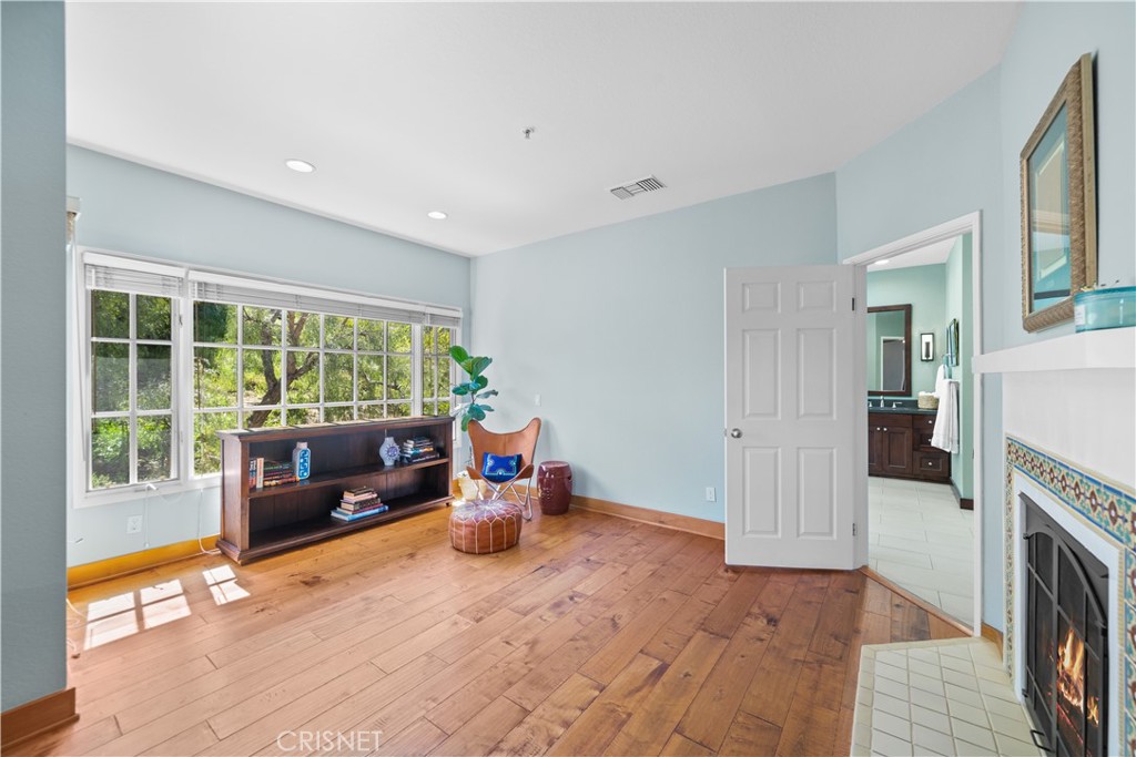 121 Saddlebow Road Bell Canyon, CA 91307 - Photo 31 of 62 a living room with furniture a fireplace and a floor to ceiling window