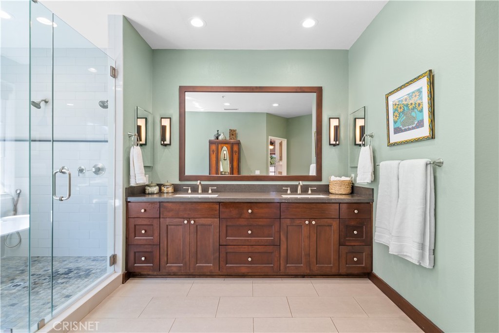 121 Saddlebow Road Bell Canyon, CA 91307 - Photo 34 of 62 a spacious bathroom with a granite countertop sink mirror and a bathtub