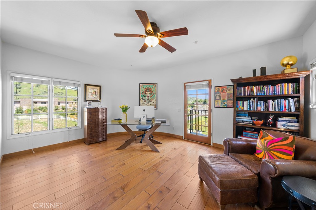121 Saddlebow Road Bell Canyon, CA 91307 - Photo 36 of 62 a living room with furniture a bookshelf and a window