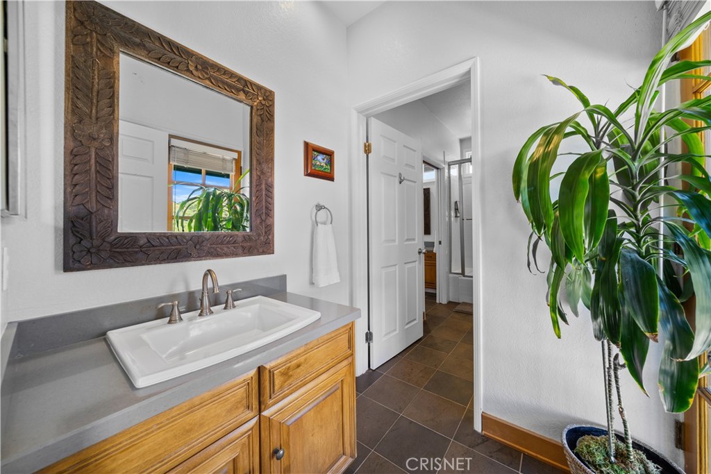 121 Saddlebow Road Bell Canyon, CA 91307 - Photo 39 of 62 a bathroom with a sink a mirror and a potted plant