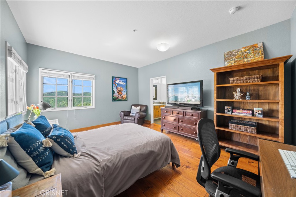 121 Saddlebow Road Bell Canyon, CA 91307 - Photo 42 of 62 a bedroom with a bed and large windows