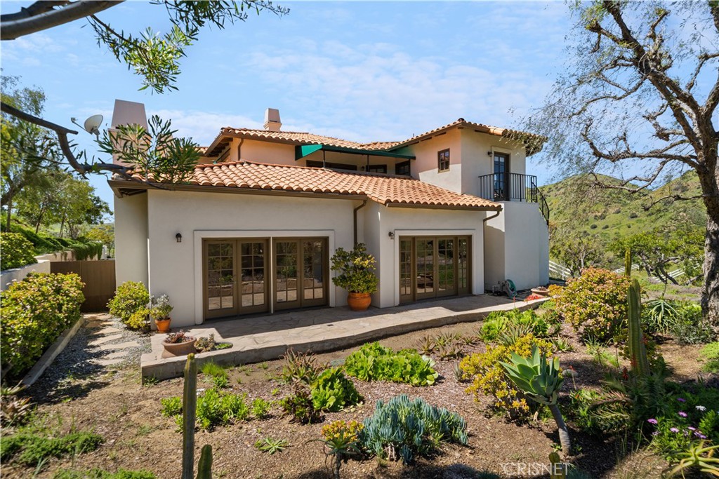 121 Saddlebow Road Bell Canyon, CA 91307 - Photo 43 of 62 front view of a house with potted plants and a bench