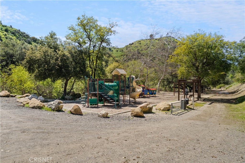121 Saddlebow Road Bell Canyon, CA 91307 - Photo 62 of 62 a row of palm trees and fire pit in the patio