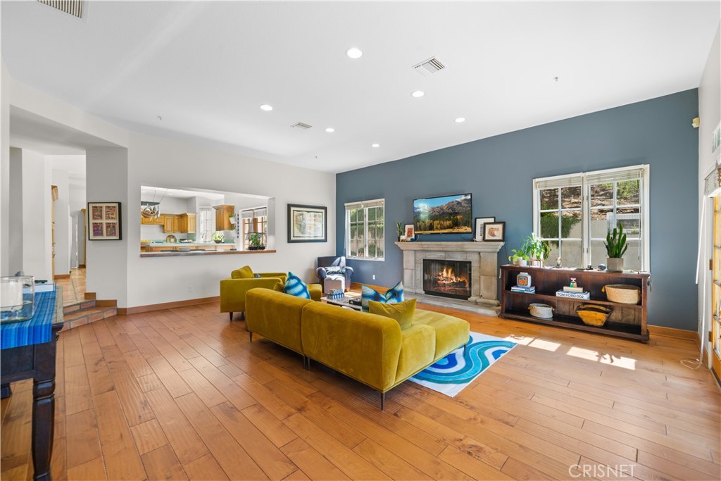 121 Saddlebow Road Bell Canyon, CA 91307 - Photo 8 of 62 a living room with furniture and a fireplace with wooden floor