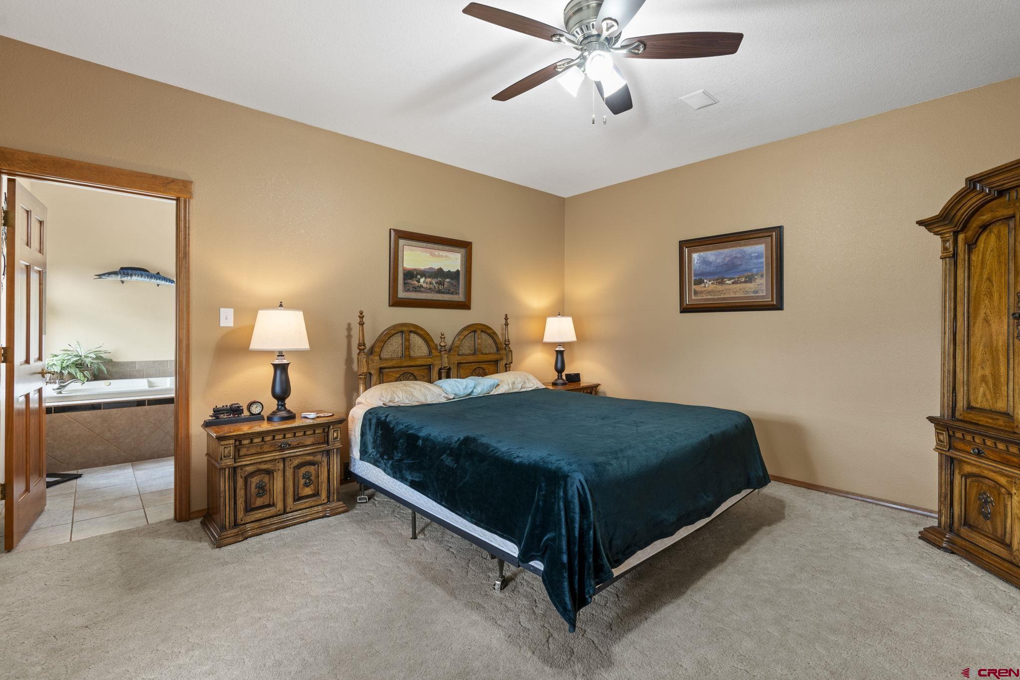 33140 Highway 550 Durango, CO 81301 - Photo 12 of 38 a bedroom with a bed and a chandelier