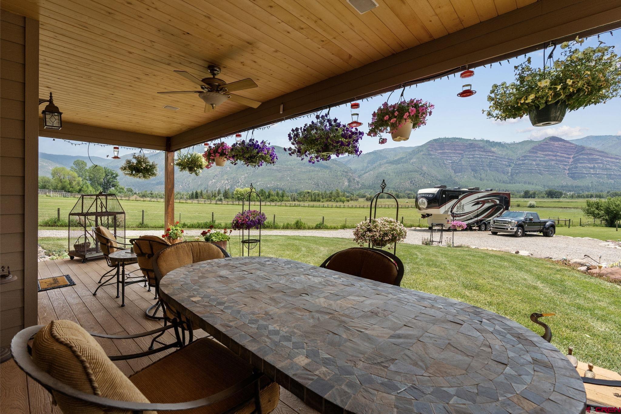33140 Highway 550 Durango, CO 81301 - Photo 26 of 38 a view of a patio with a table chairs and a backyard