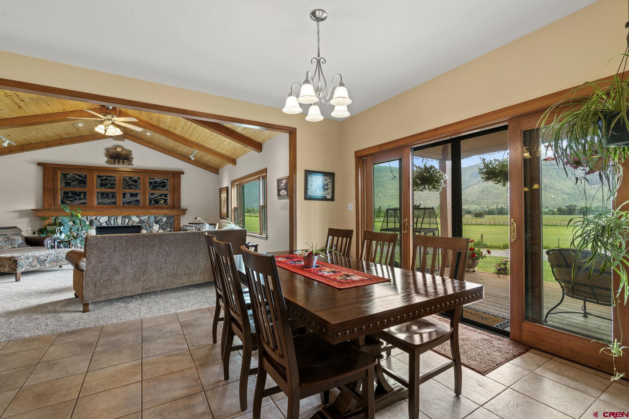 33140 Highway 550 Durango, CO 81301 - Photo 7 of 38 a view of a dining room with furniture large windows and wooden floor