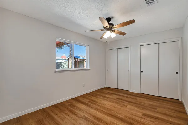 a backyard of a house with barbeque oven table and chairs