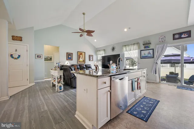 a open kitchen with cabinets a sink and appliances