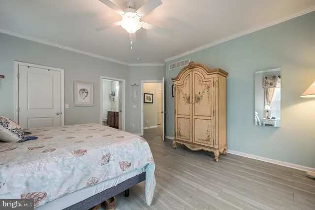 a spacious bedroom with a bed and a chandelier