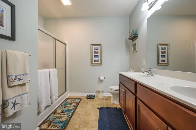 a bathroom with a double vanity sink and mirror