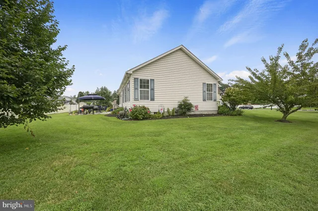 a view of backyard of house with green space