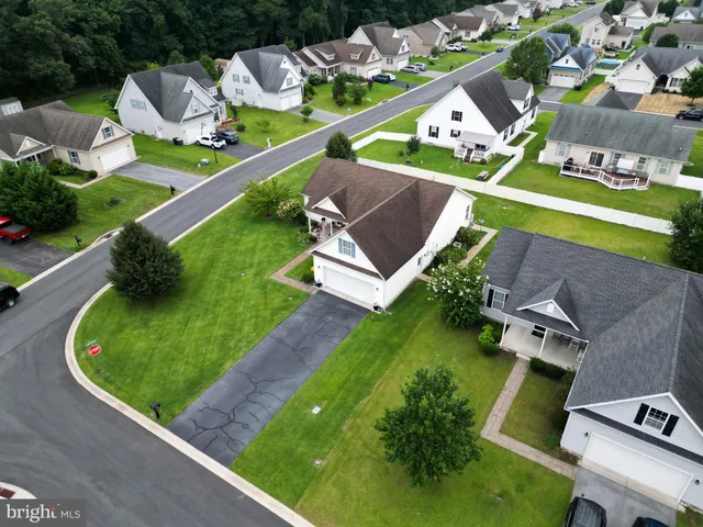 an aerial view of a house with a garden and swimming pool