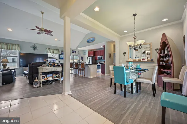 a dining room with furniture and wooden floor