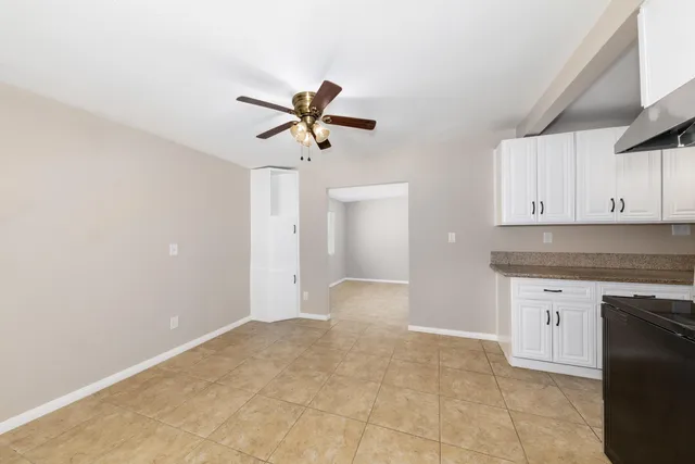 a view of a kitchen with a sink and a chandelier