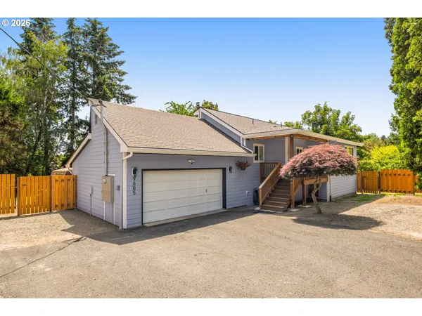 a view of a house with a garage and yard