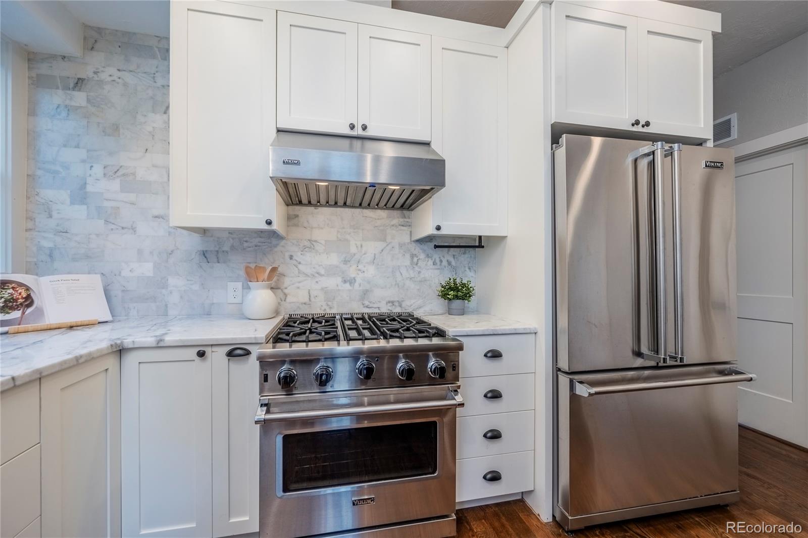 1367 Monroe Street Denver, CO 80206 - Photo 11 of 48 a kitchen with a stove and a refrigerator