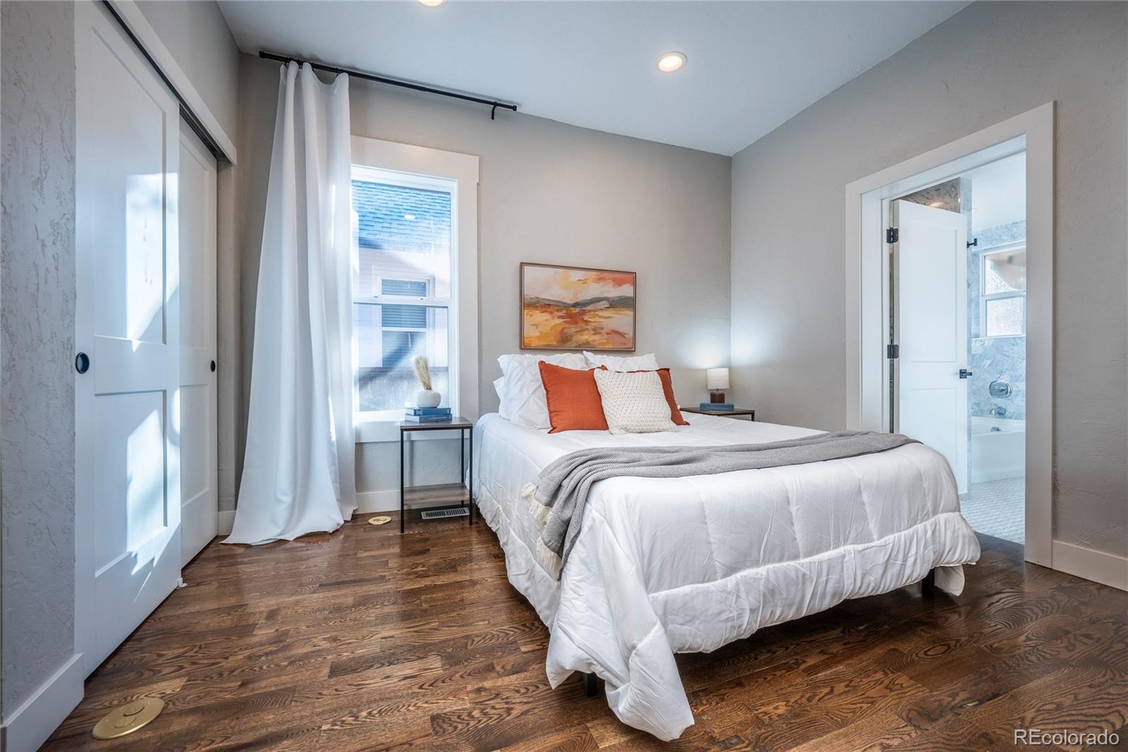 1367 Monroe Street Denver, CO 80206 - Photo 13 of 48 a bedroom with a bed and wooden floor