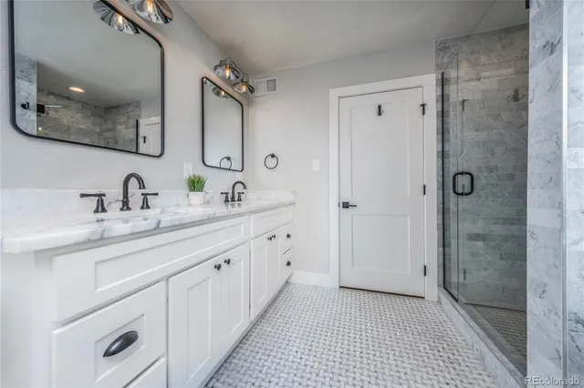 a spacious bathroom with a granite countertop sink mirror and a