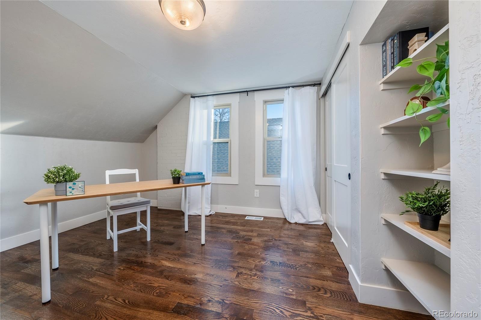 1367 Monroe Street Denver, CO 80206 - Photo 27 of 48 a view of a dining room with furniture wooden floor and front door