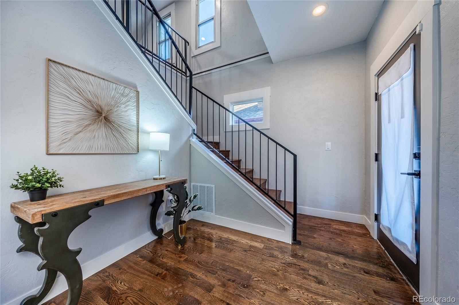 1367 Monroe Street Denver, CO 80206 - Photo 3 of 48 a view of entryway with wooden floor and stairs