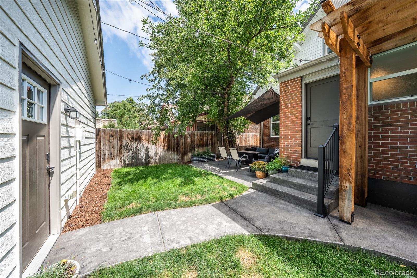 1367 Monroe Street Denver, CO 80206 - Photo 37 of 48 a view of a house with backyard and sitting area