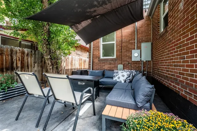 a view of patio with a table and chairs and potted plants