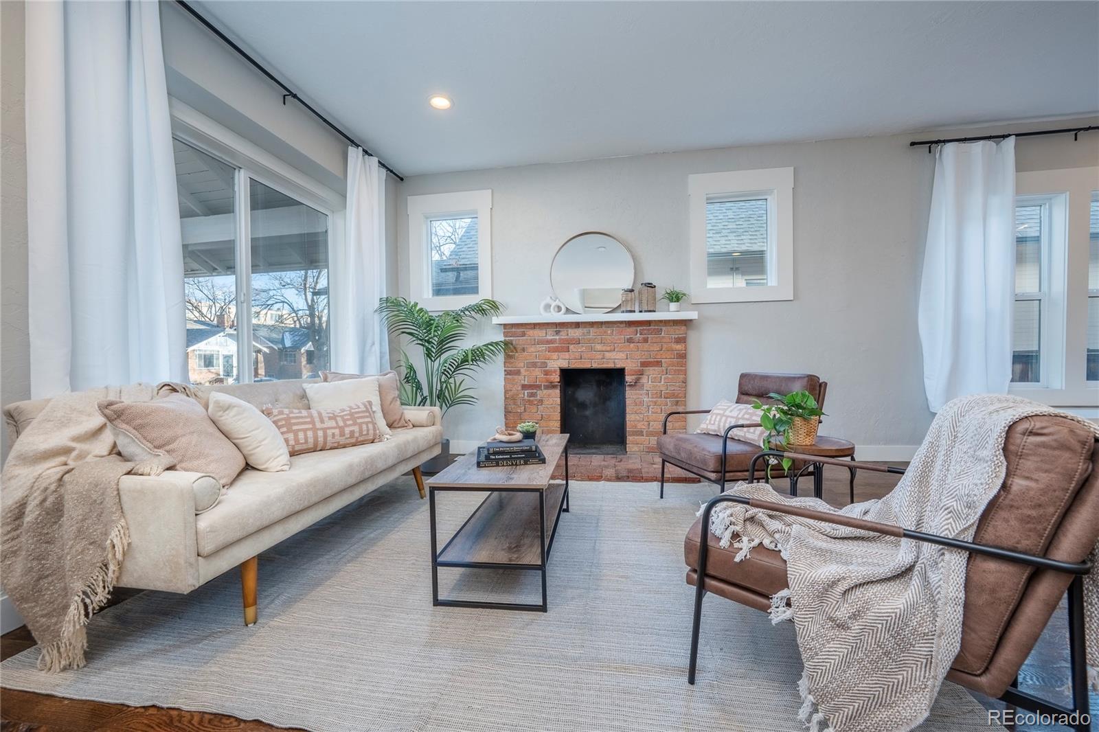 1367 Monroe Street Denver, CO 80206 - Photo 4 of 48 a living room with furniture and a fireplace