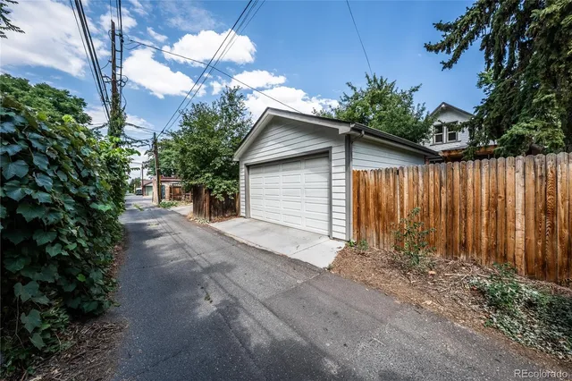 a view of a house with a yard and tree s