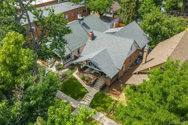 an aerial view of a house with a yard