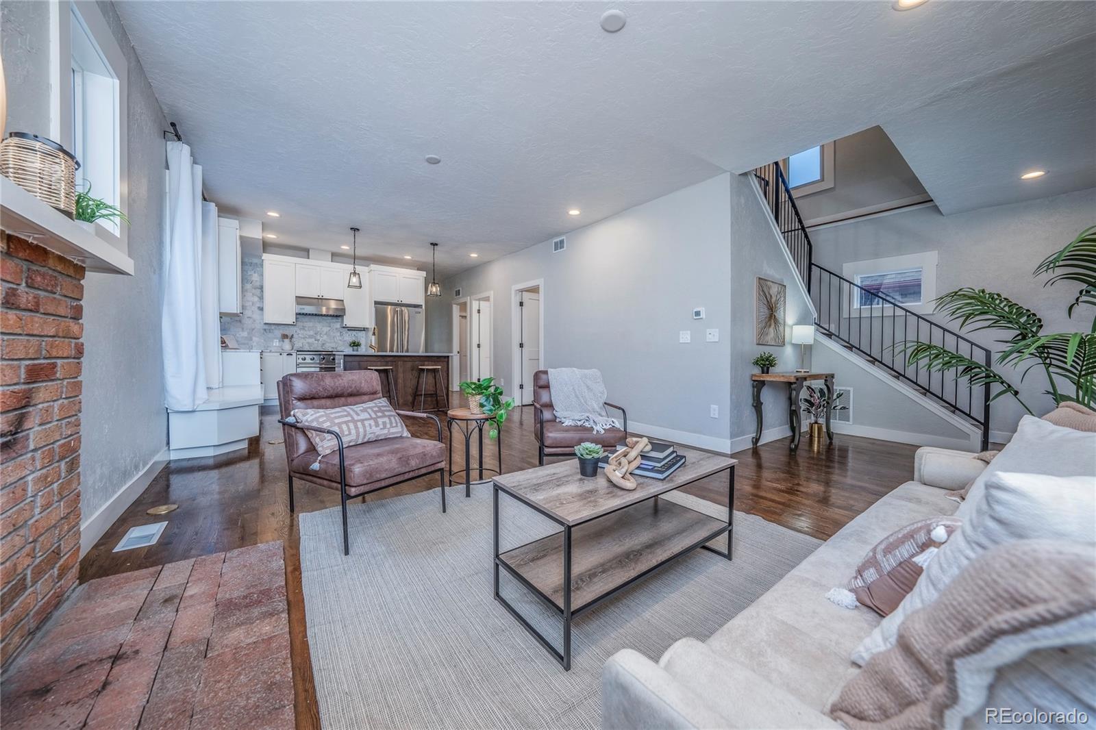 1367 Monroe Street Denver, CO 80206 - Photo 5 of 48 a living room with furniture and a rug