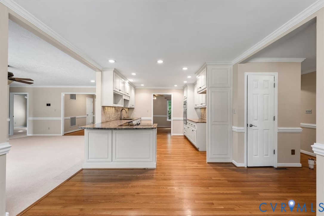 1437 Palmore Road Powhatan, VA 23139 - Photo 14 of 60 Kitchen featuring white cabinetry, wood-finish flo