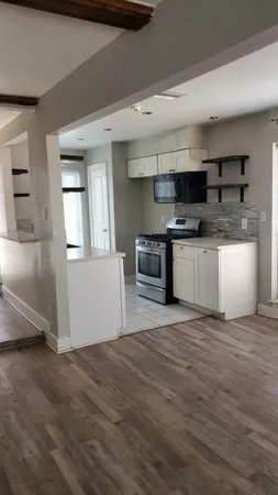 a kitchen with stainless steel appliances granite countertop a stove a sink and a microwave