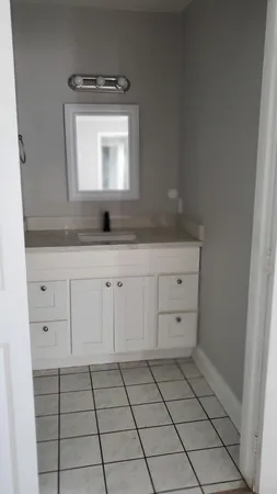 a bathroom with a sink a toilet and mirror