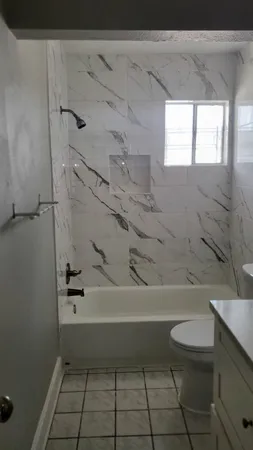 a bathroom with a toilet a sink and a bathtub