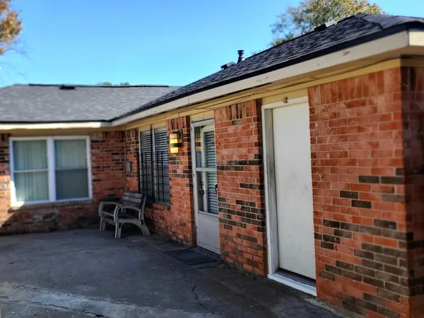 a front view of a house with outdoor seating