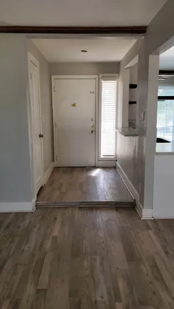 a view of a hallway with wooden shelves