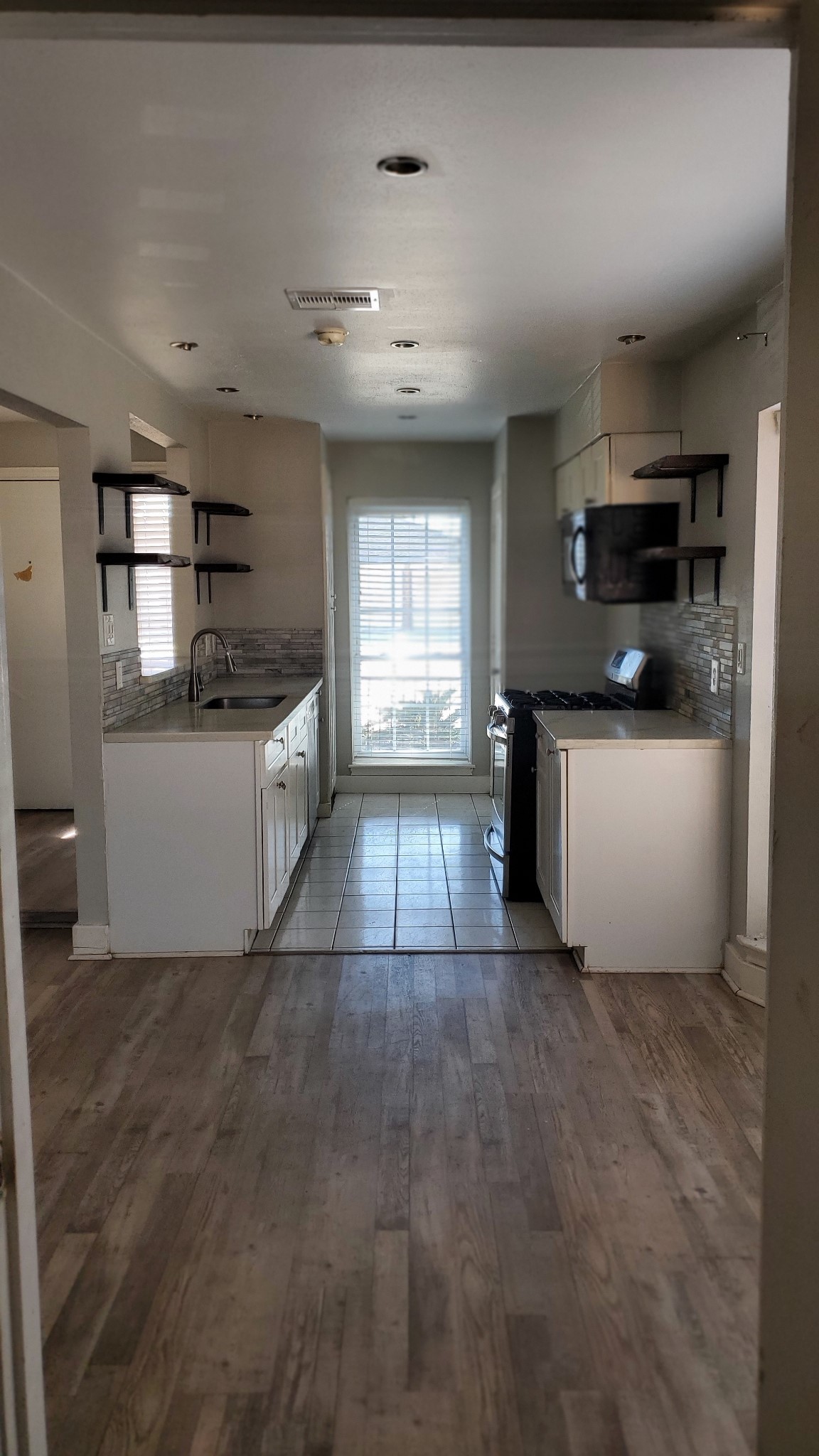 15414 West Hampton Circle Houston, TX 77071 - Photo 9 of 30 a view of a kitchen with a sink dishwasher and fireplace