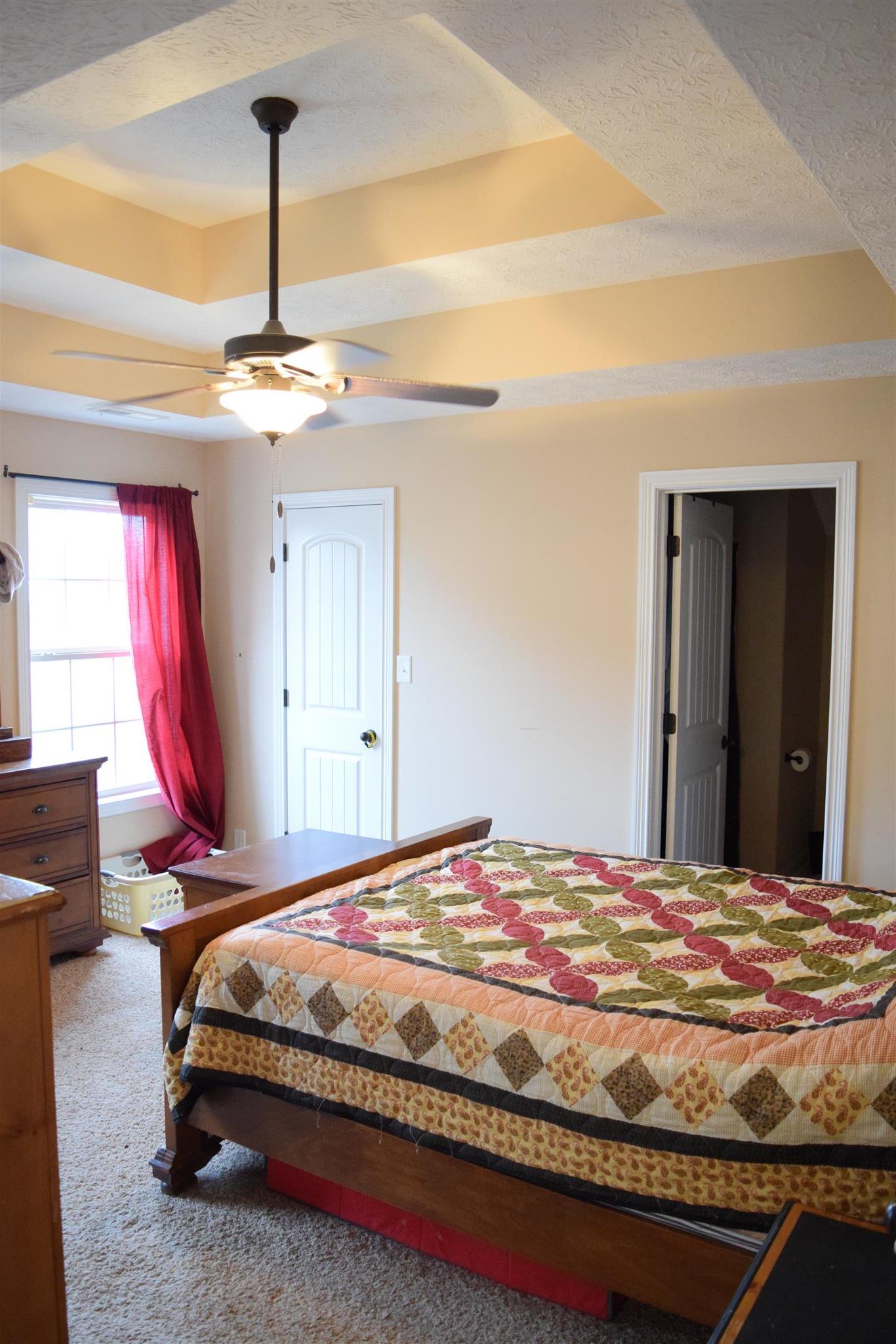 1494 Raven Road Clarksville, TN 37042 - Photo 11 of 25 a bedroom with a bed and a chandelier