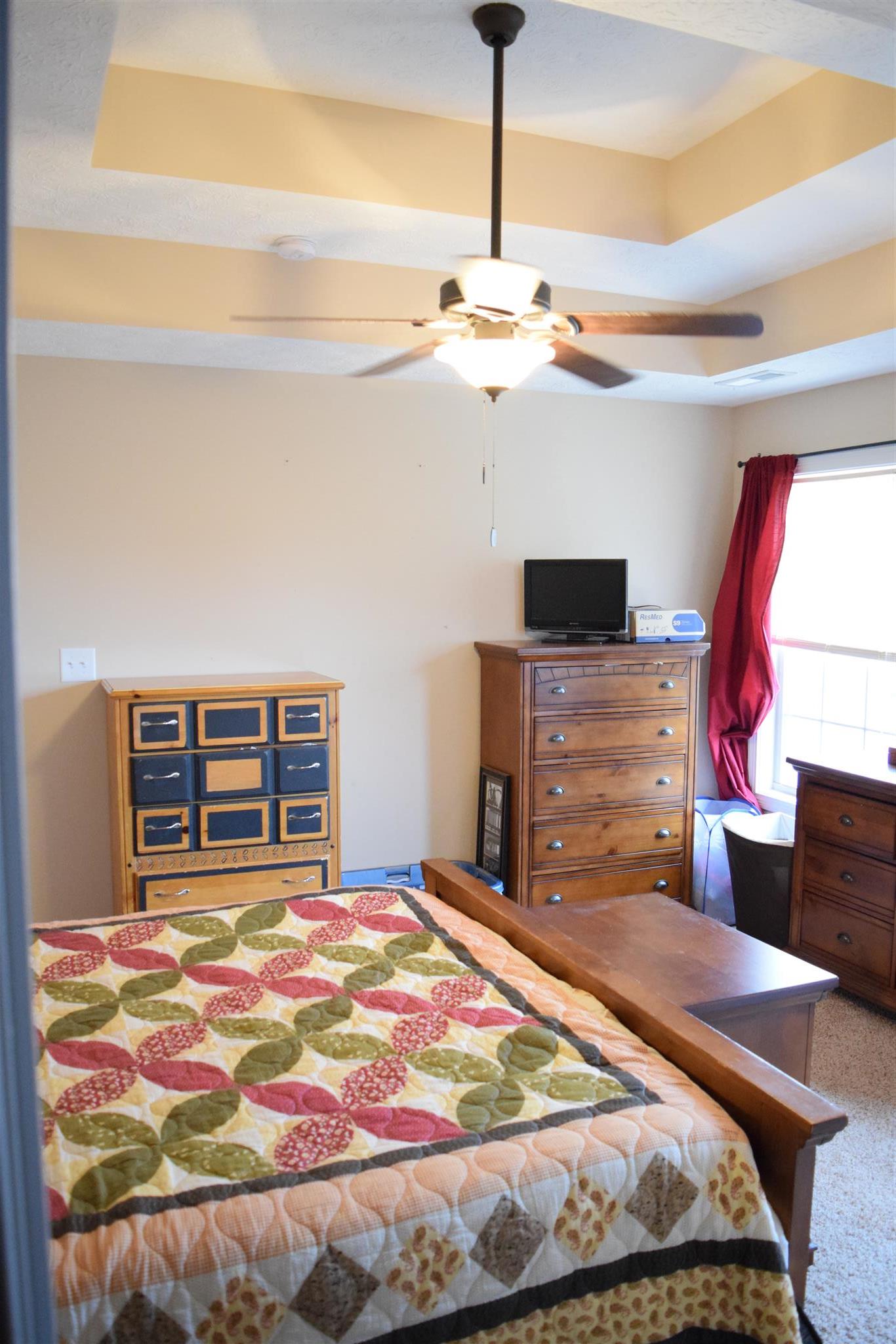 1494 Raven Road Clarksville, TN 37042 - Photo 12 of 25 a bedroom with a bed and a chandelier