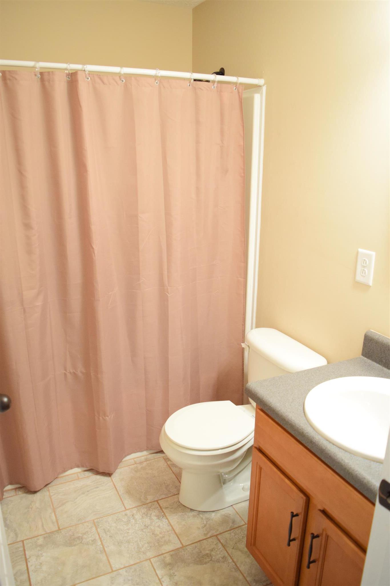1494 Raven Road Clarksville, TN 37042 - Photo 16 of 25 a white toilet sitting next to a shower curtain