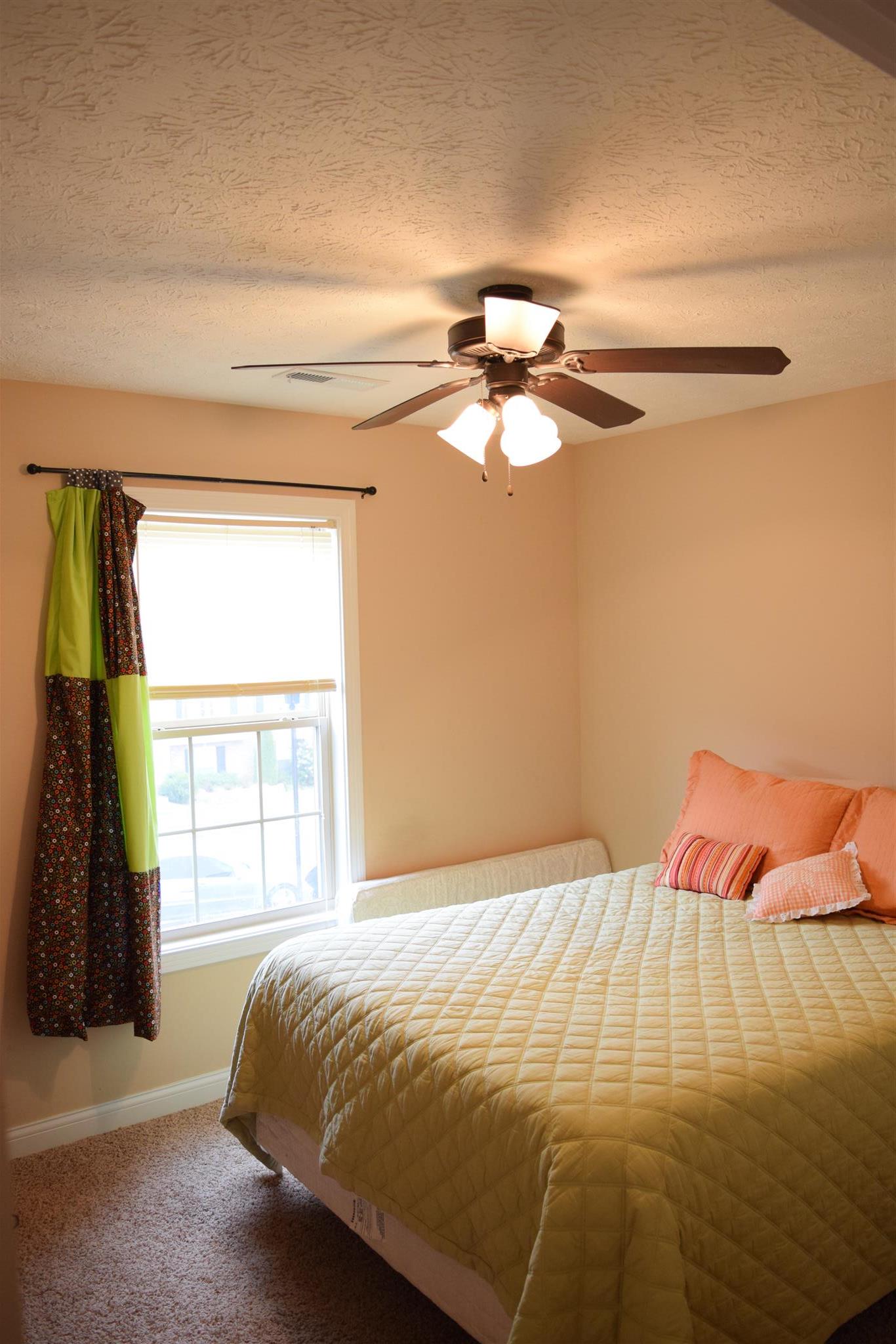 1494 Raven Road Clarksville, TN 37042 - Photo 17 of 25 a bedroom with a bed and a chandelier