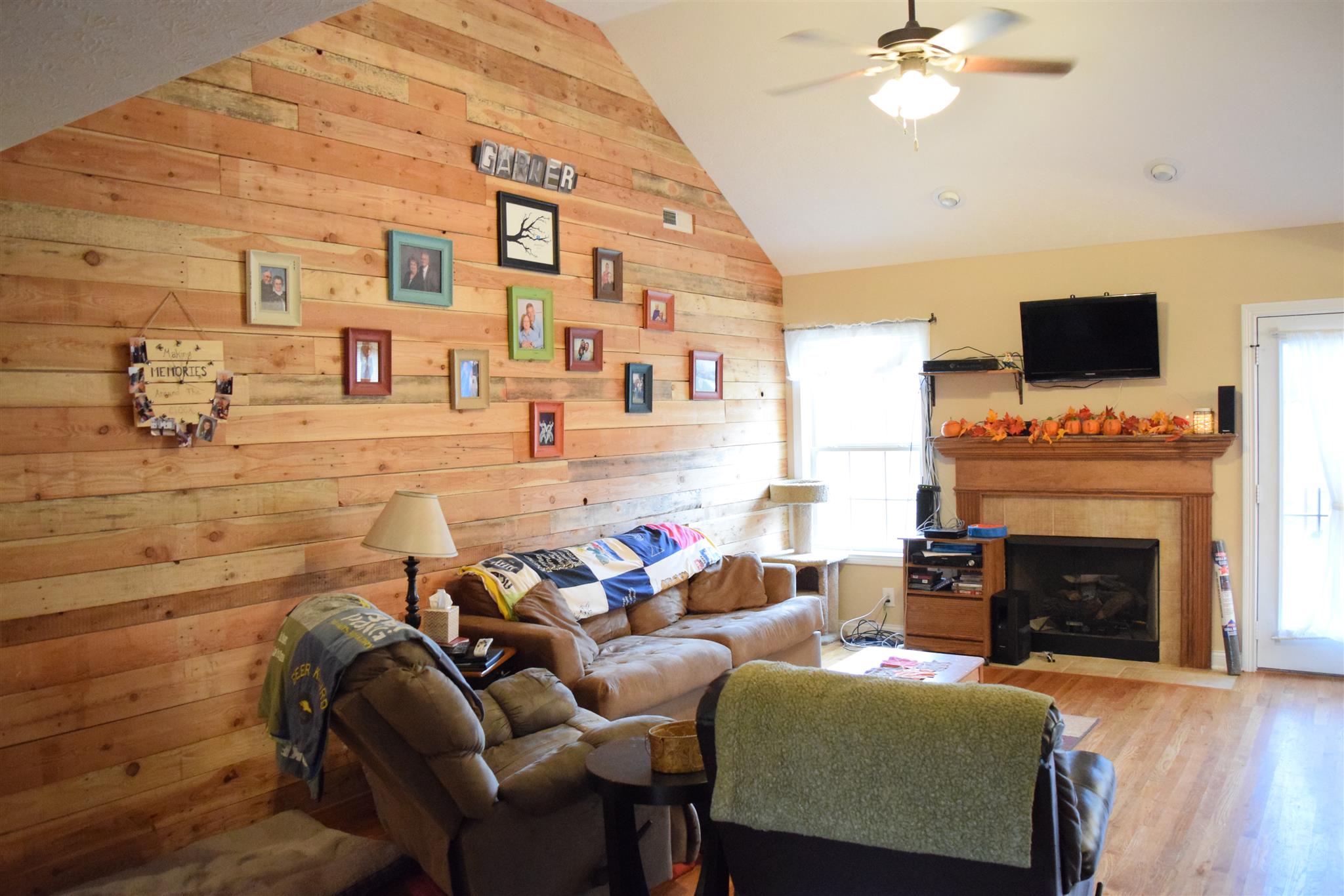 1494 Raven Road Clarksville, TN 37042 - Photo 4 of 25 a living room with furniture a fireplace and a flat screen tv